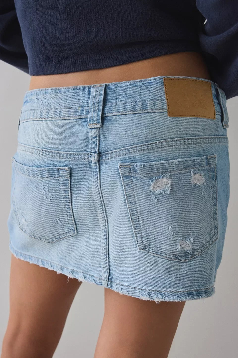Light Wash Distressed Denim Mini Skirt